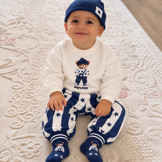 Baby wearing navy bear outfit with star striped joggers beanie and socks