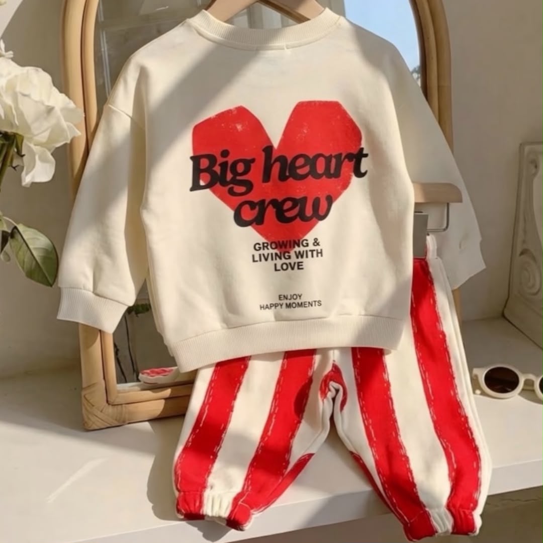 Back of cream sweatshirt with red heart graphic and matching striped trousers