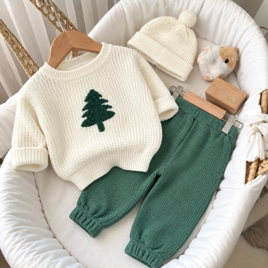 Cream Christmas tree knit jumper with green trousers and white pom-pom beanie