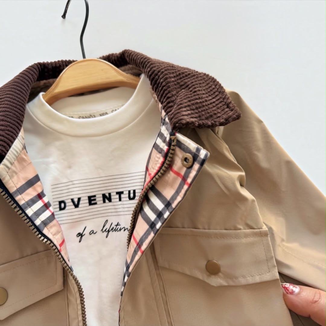Close-up of beige baby boy jacket with corduroy collar and checked trim