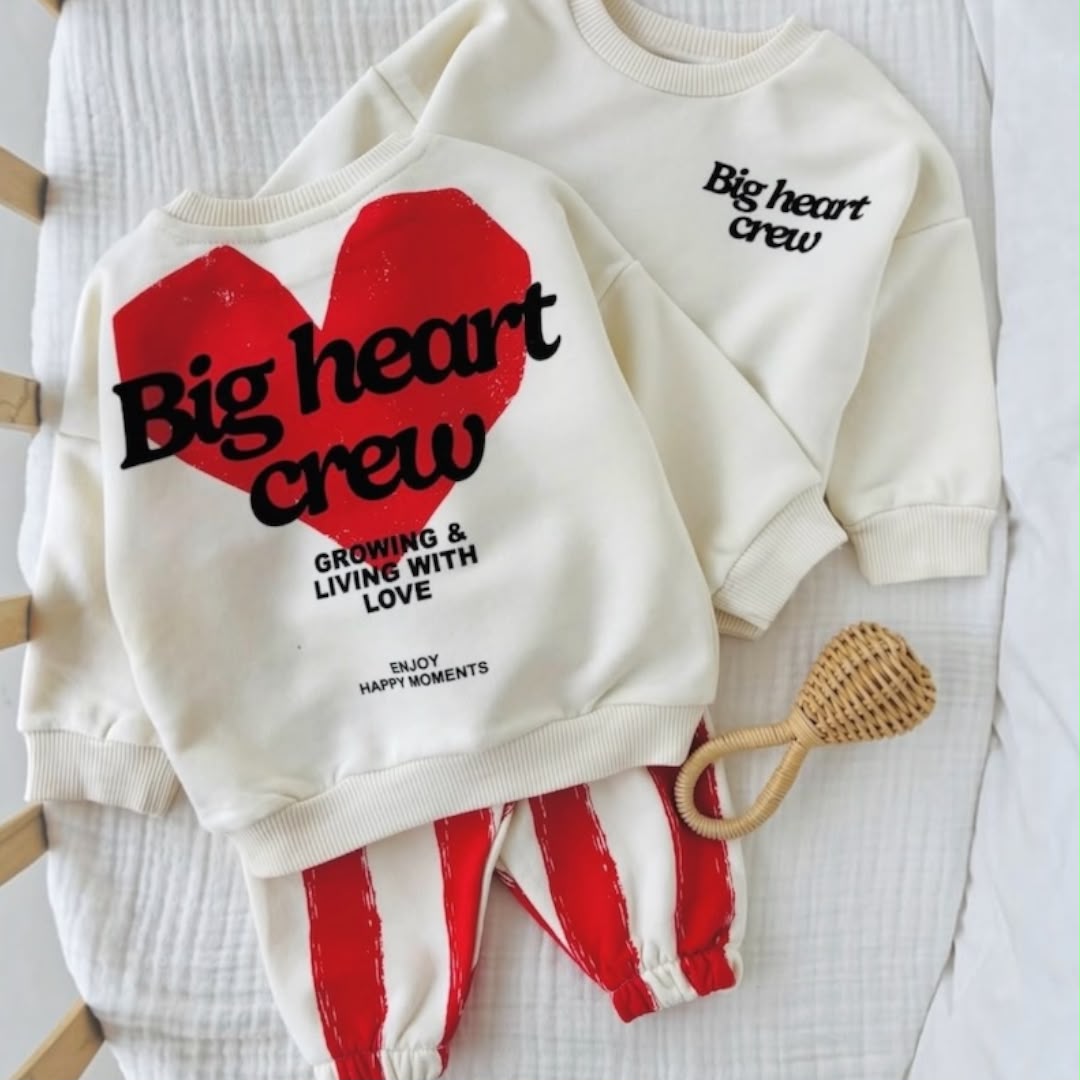 Cream Big Heart Crew sweatshirt showing front and back prints with red striped joggers