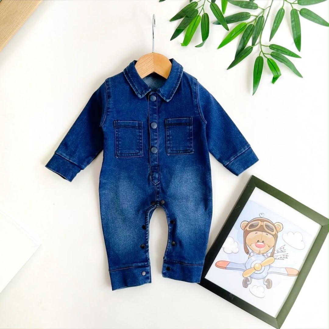 Baby Denim Shirt Collar Romper flat lay on hanger with botanical decor