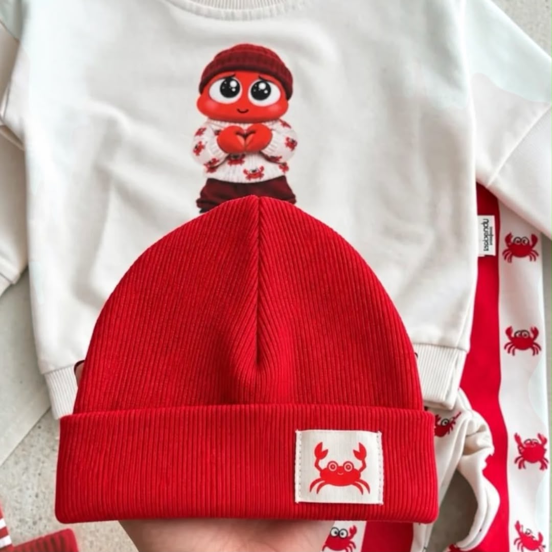 Close-up of red ribbed baby beanie with crab patch