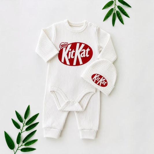 Baby Ribbed White Logo Print Romper & Hat Set flat lay with tropical leaves