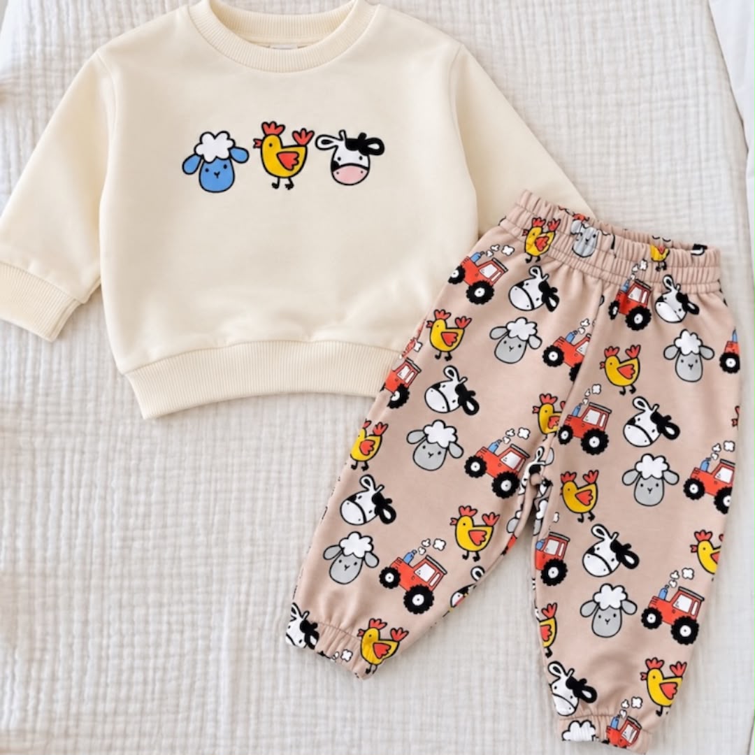Cream baby sweatshirt with sheep chicken and cow graphics and pink farm-print joggers