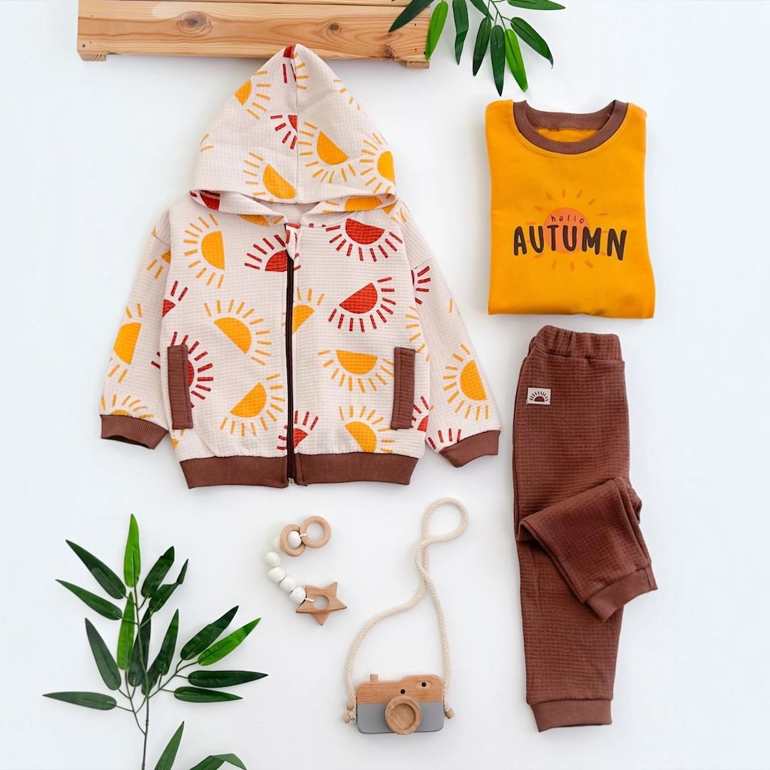Hello Autumn baby 3-piece set flat lay with sun-print hoodie, mustard sweatshirt and brown joggers