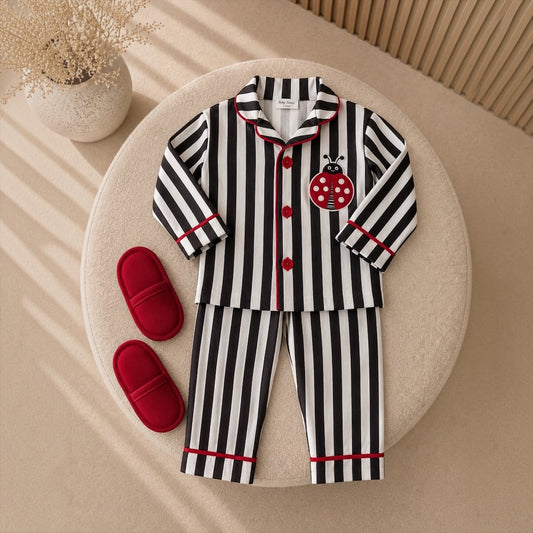 Kids Striped Pyjama Set Ladybug design flat lay with red slippers