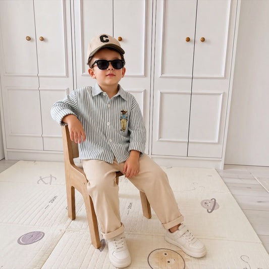 Boy wearing Bear Stripe Green Set sitting with sunglasses