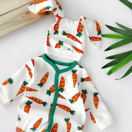 Close-up of white baby romper with colorful carrot print and green trim