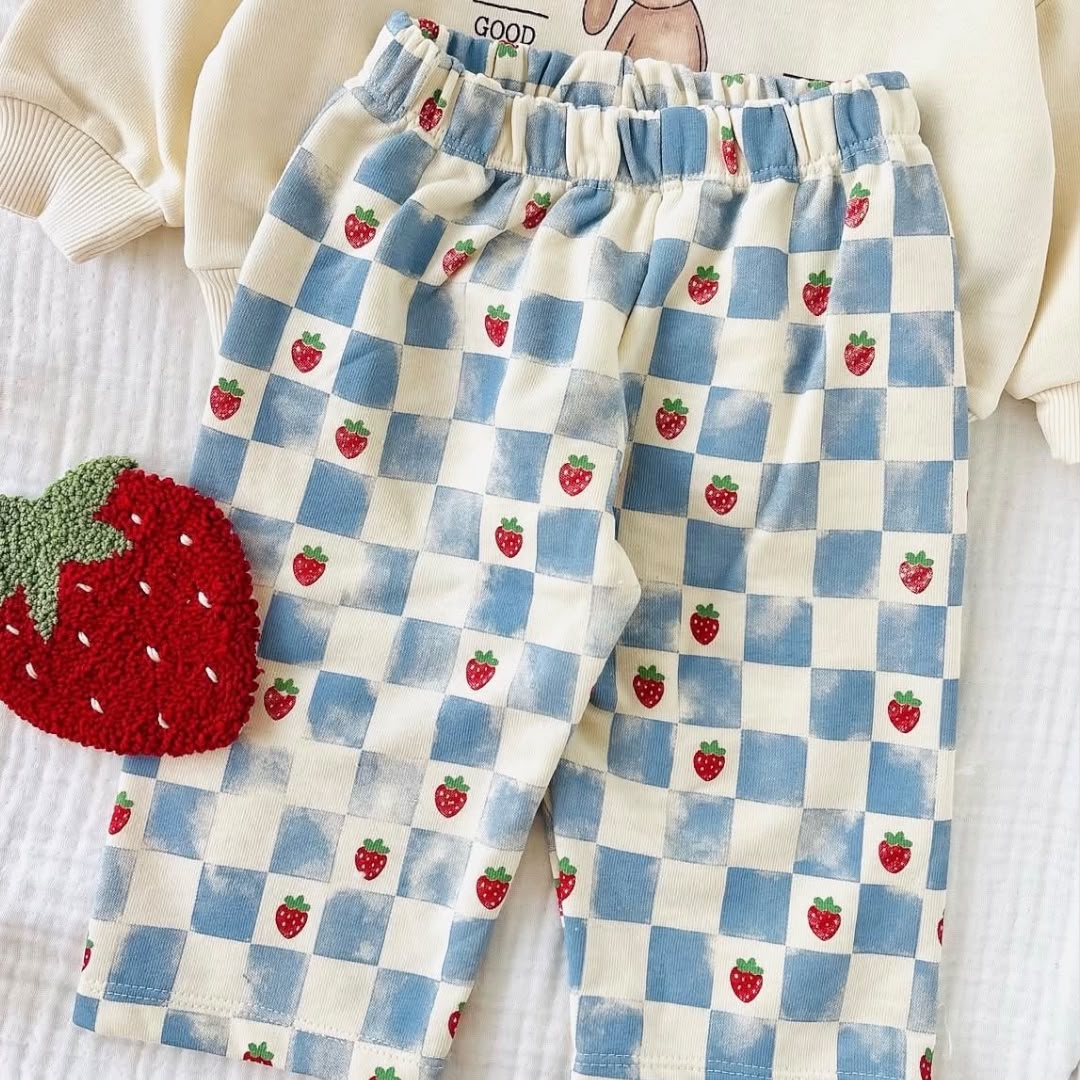Close-up of blue and cream checkered strawberry trousers with elasticated waistband