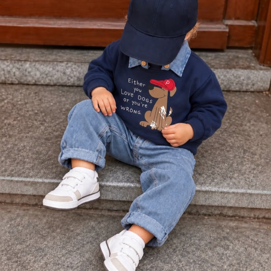 Toddler wearing navy dog-print collared sweatshirt and light-blue jeans